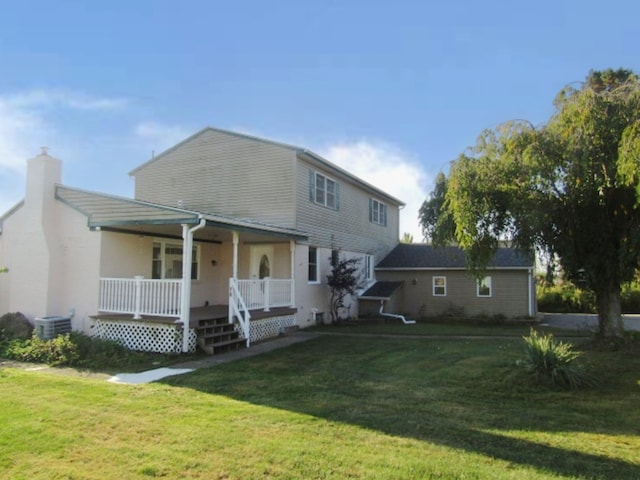 view of front of house with central AC, covered porch, and a front lawn