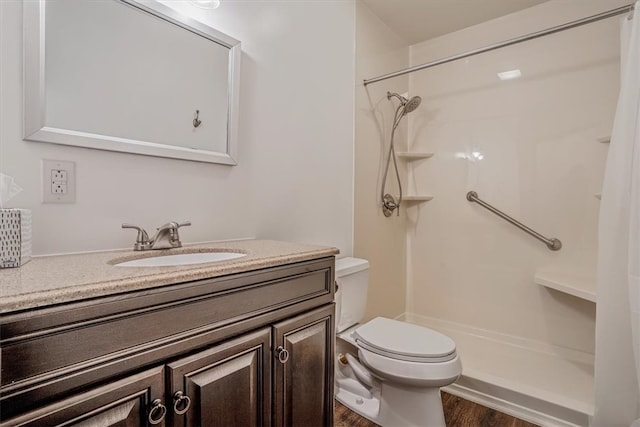 bathroom featuring vanity, toilet, curtained shower, and hardwood / wood-style floors