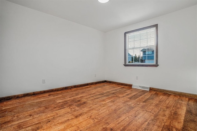 empty room with wood-type flooring