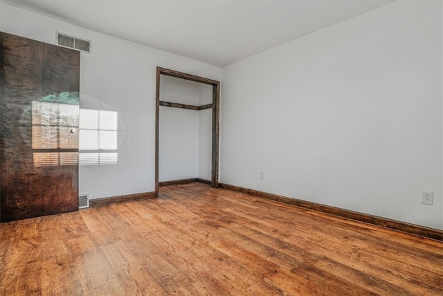 unfurnished bedroom featuring a closet and light hardwood / wood-style floors