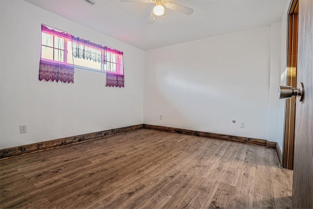 empty room with hardwood / wood-style flooring and ceiling fan