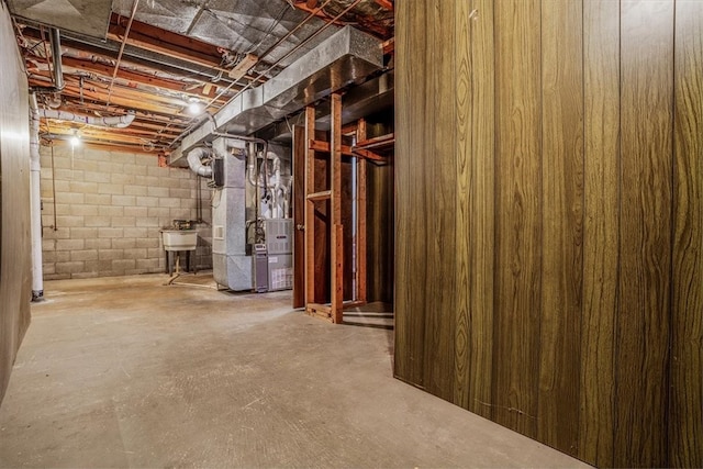 basement featuring sink and heating unit