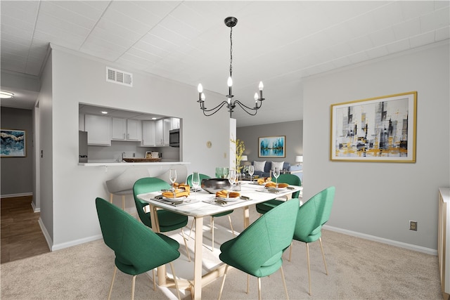 carpeted dining room featuring an inviting chandelier