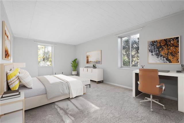 bedroom with built in desk and light colored carpet