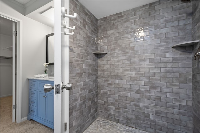 bathroom featuring vanity and tiled shower