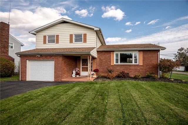 view of front of house with a garage and a front lawn