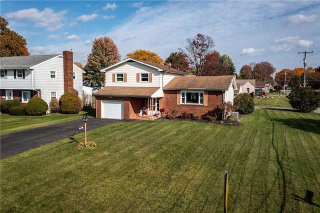 view of front of house with a front lawn and a garage