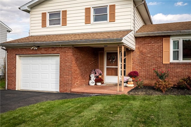 view of front of home with a front yard and a garage