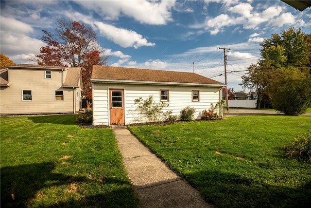 back of property with a lawn