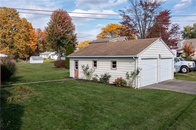 exterior space featuring an outdoor structure, a garage, and a yard