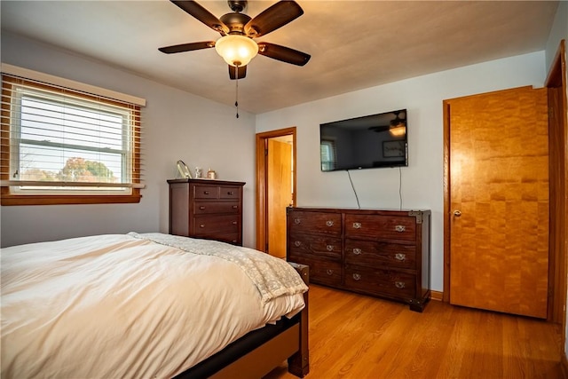 bedroom featuring light wood-type flooring and ceiling fan