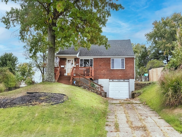 view of front of home with a front yard and a garage