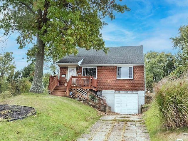 view of front facade with a front lawn, a wooden deck, and a garage