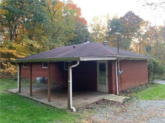 561 Williams Ave, Rochester Twp, PA 15074 - back of property featuring brick siding, a patio, a chimney, and a shingled roof