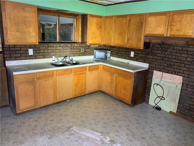 561 Williams Ave, Rochester Twp, PA 15074 - kitchen featuring black microwave, light countertops, and brick patterned flooring