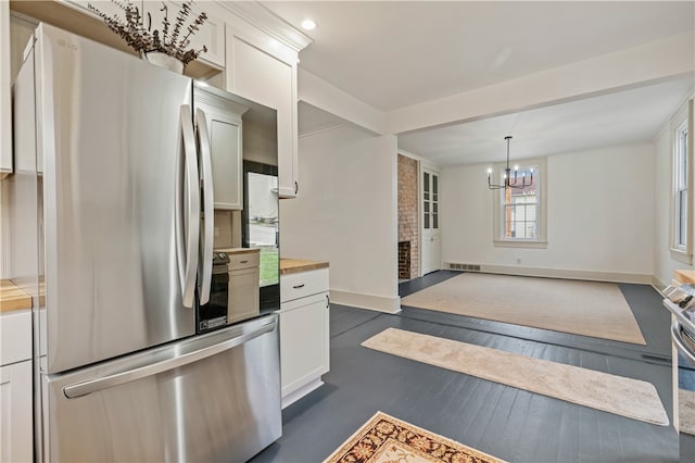 kitchen featuring dark wood-type flooring, white cabinetry, and stainless steel fridge