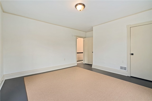 unfurnished room featuring crown molding