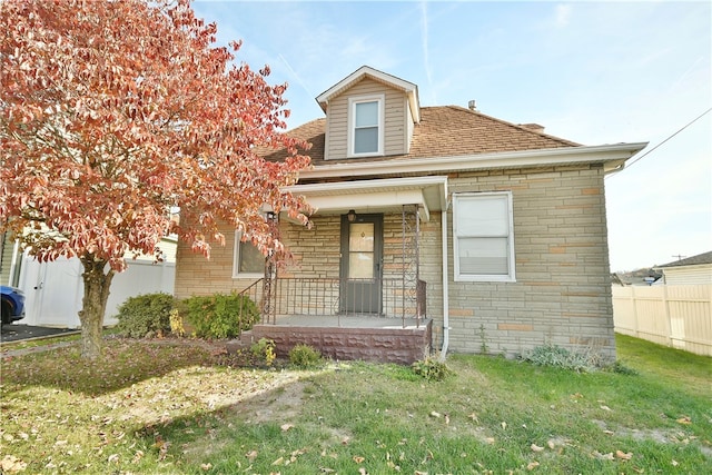 view of front facade with a front yard and covered porch