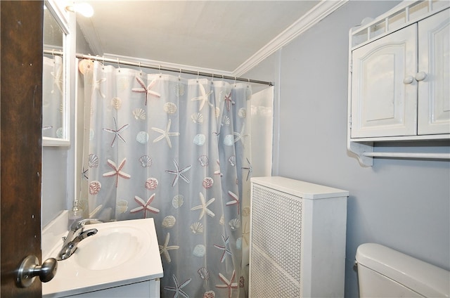 bathroom with vanity, crown molding, toilet, and walk in shower