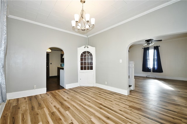 unfurnished dining area featuring ornamental molding, hardwood / wood-style flooring, and ceiling fan with notable chandelier