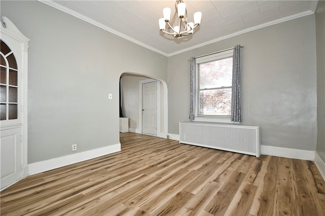 unfurnished dining area with a chandelier, crown molding, radiator heating unit, and light wood-type flooring