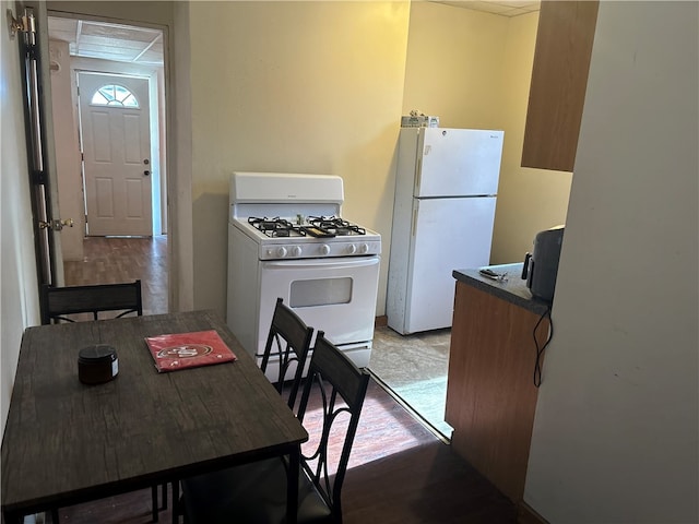 kitchen with light hardwood / wood-style floors and white appliances