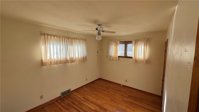 empty room with ceiling fan and wood-type flooring