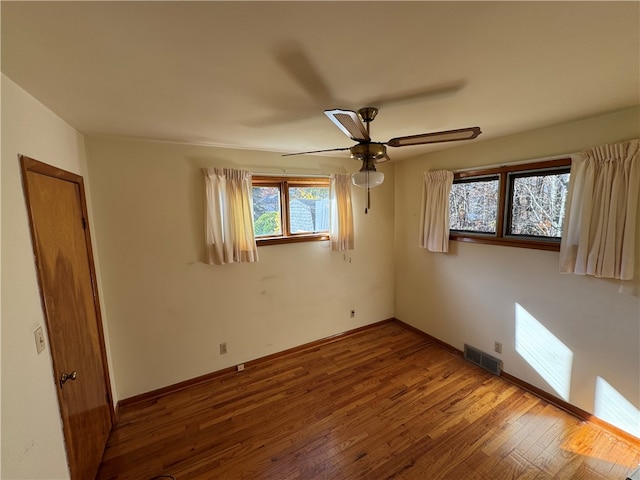 unfurnished room featuring ceiling fan and hardwood / wood-style floors