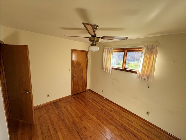 unfurnished bedroom with ceiling fan and hardwood / wood-style floors