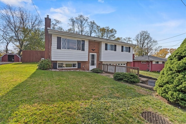 split foyer home with a wooden deck, a front yard, and a storage unit