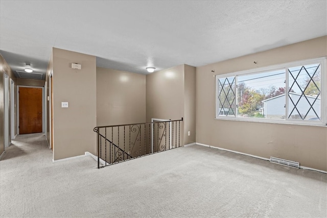 unfurnished room featuring carpet floors