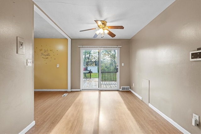 spare room with light wood-type flooring and ceiling fan