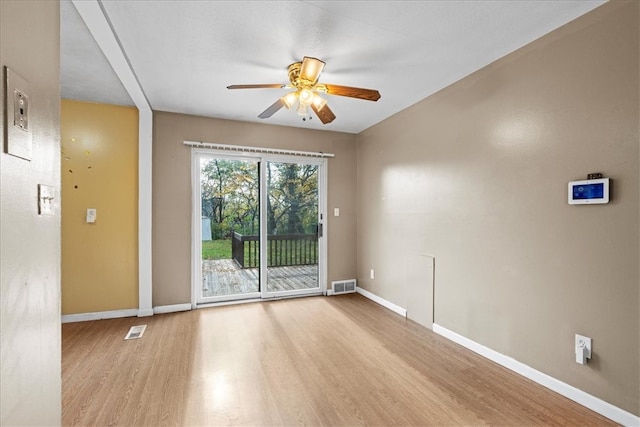 spare room with light wood-type flooring and ceiling fan