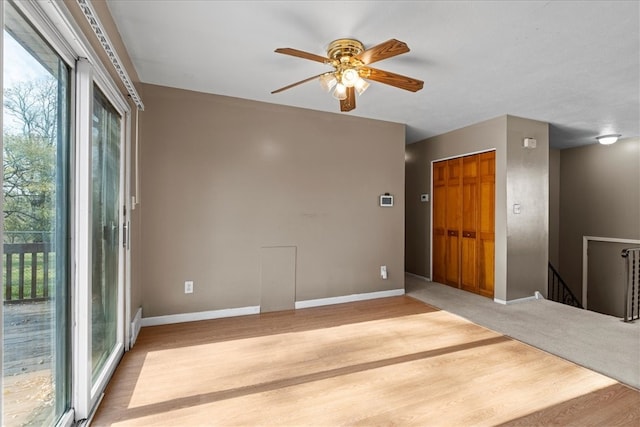 empty room with wood-type flooring and ceiling fan