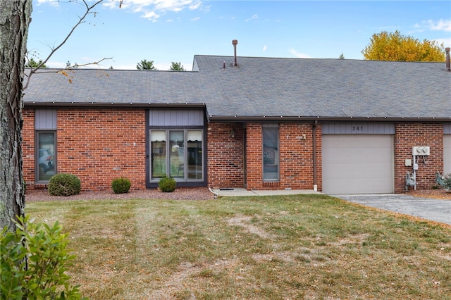 rear view of house featuring a garage and a lawn