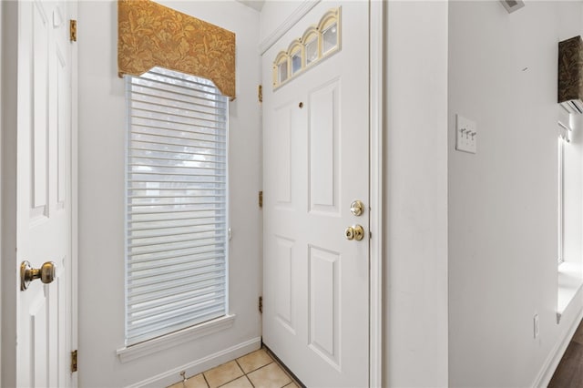 doorway to outside with light tile patterned floors