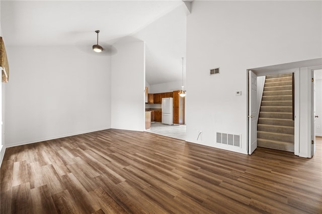 unfurnished living room featuring high vaulted ceiling and hardwood / wood-style flooring