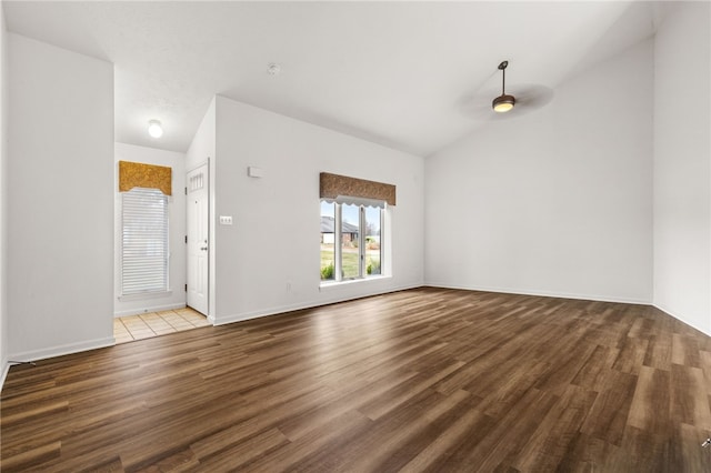 unfurnished living room featuring a textured ceiling, hardwood / wood-style flooring, and vaulted ceiling