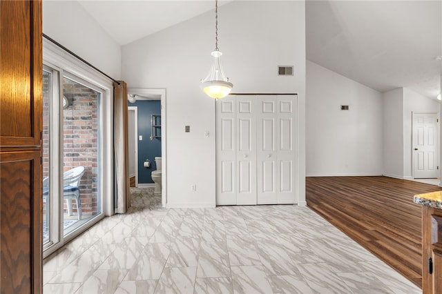 unfurnished bedroom featuring multiple windows, access to outside, and lofted ceiling