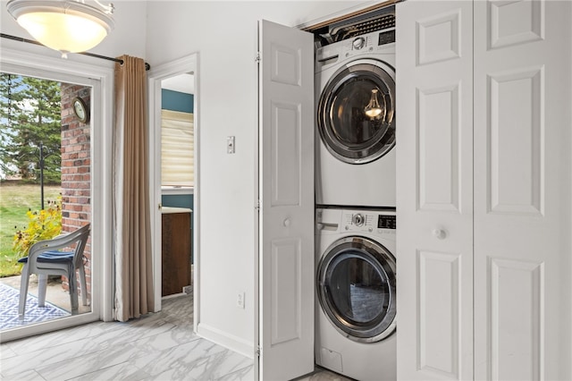 clothes washing area featuring stacked washer / dryer