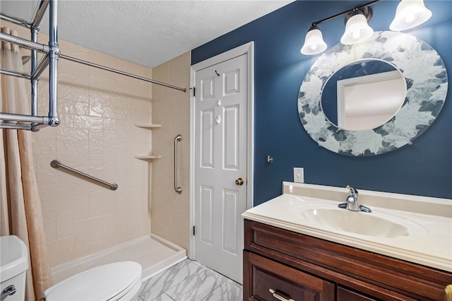 bathroom featuring toilet, a textured ceiling, a shower with curtain, and vanity