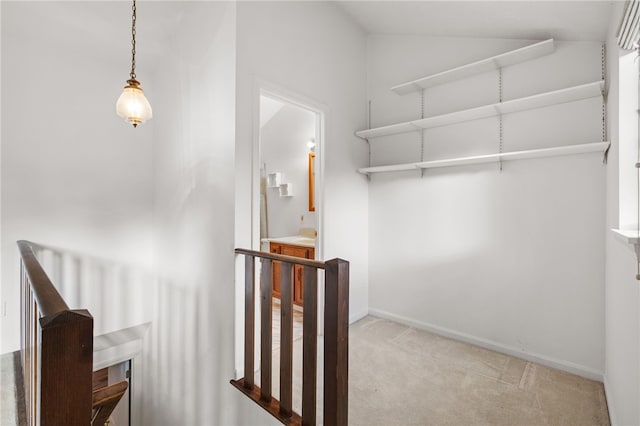 stairway with vaulted ceiling and carpet floors