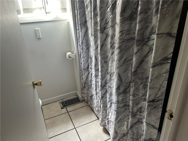 bathroom with tile patterned floors and a shower with shower curtain