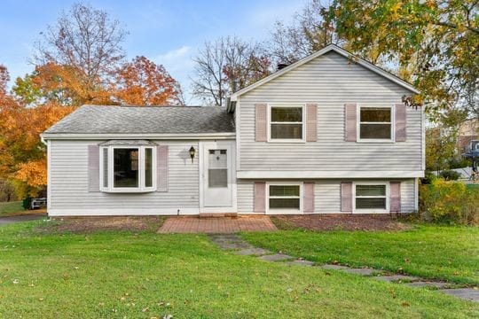 split level home featuring a front lawn