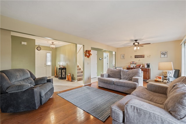 living room featuring ceiling fan and light hardwood / wood-style flooring