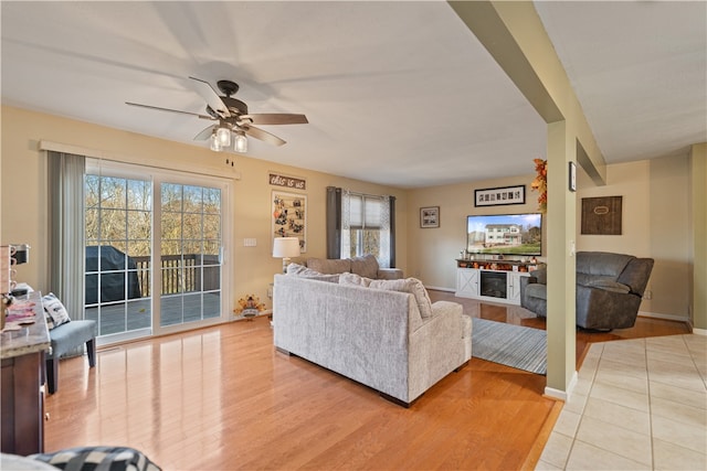 living room featuring light hardwood / wood-style floors, a wealth of natural light, and ceiling fan