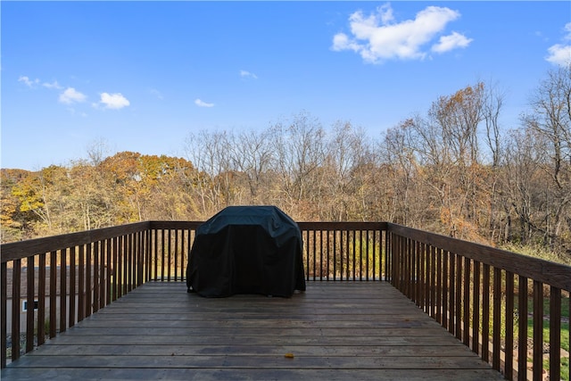 wooden deck featuring a grill