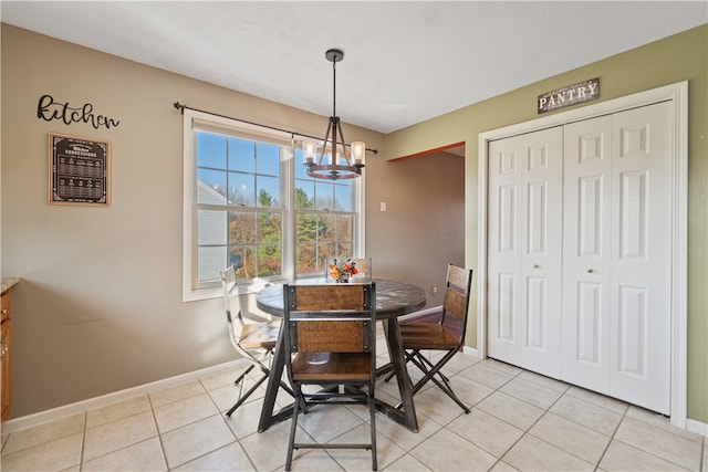 dining room with a notable chandelier and light tile patterned flooring