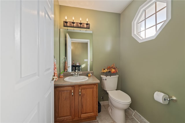 bathroom with tile patterned floors, vanity, and toilet