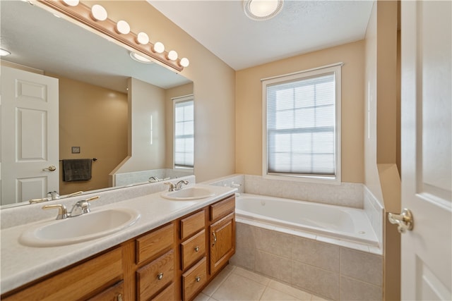 bathroom with tile patterned flooring, vanity, and tiled tub